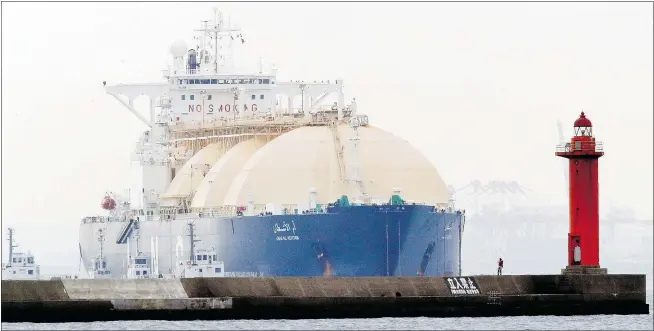  ?? — AP FILES ?? B.C. or Canada could also manufactur­e LNG tankers similar to the Umm Al Ashtan, here arriving at a port in Yokohama, Japan, in 2013, as part of a visionary leap into the world’s liquefied natural gas trade, argues business professor Robert Deane of...