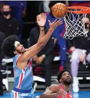  ?? AP ?? Jarrett Allen ( left) of Brooklyn Nets reaches for a rebound above Joel Embiid of Philadelph­ia 76ers during their NBA game in New York on Thursday. Nets won 122- 109. —