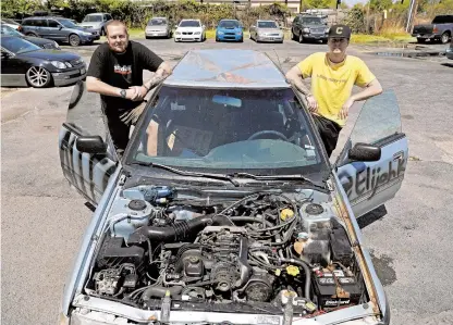  ?? JONATHON GRUENKE/STAFF ?? Tony Gower, left, and Elijah Knapp stand next to a 1992 Subaru Legacy this week. The two Norfolk men found the car with a sign that said “free” in the windshield in Colorado and drove the vehicle back to Virginia.