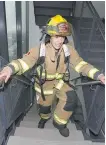  ?? JIM WELLS ?? A firefighte­r hits the last couple of stairs during Sunday’s fundraiser at the Bow Building.