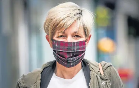  ?? Picture: Mhairi Edwards. ?? A Montrose resident dons a tartan face mask as the country enters week nine of lockdown. The image is part of our Life in Lockdown series, more of which can be viewed on pages 8 and 9 and on our website thecourier.co.uk.