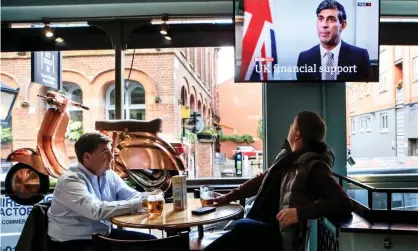  ?? Photograph: Danny Lawson/PA ?? Manchester pub customers watch the chancellor, Rishi Sunak, announcing the government’s support package ahead of its three-tiered lockdown, a system scientists have called ‘a middle-of-the-road fudge’.