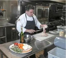  ??  ?? Gaetano Ascione cuts a whole chicken for the coq au vin, a classic French stew where the meat is braised with wine.