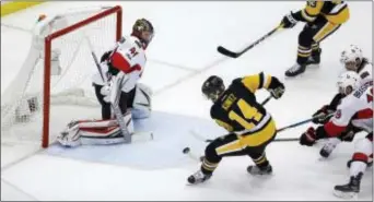  ?? THE ASSOCIATED PRESS ?? Pittsburgh left wing Chris Kunitz (14) scores a goal against Ottawa goalie Craig Anderson (41) during the second period of Game 7 of the Eastern Conference finals Thursday in Pittsburgh.