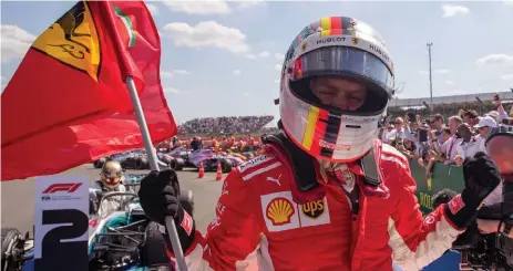  ?? Picture: EPA ?? FLYING THE FLAG FOR FERRARI: Sebastian Vettel celebrates winning the British Grand Prix yesterday.