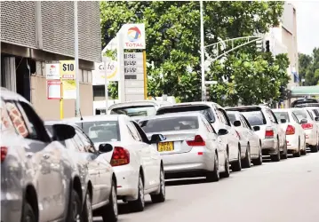  ??  ?? Cars queue for petrol at a service station along Kwame Nkrumah Avenue in Harare yesterday. A few service stations have been receiving petrol since January, with Harare going dry on some days. Picture: John Manzongo