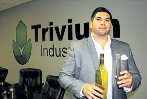  ?? ALLAN BENNER/WELLAND TRIBUNE ?? Trivium Industries founder and chief executive officer David D'Angelo holds a plastic wine bottle in this June 27, 2016, photo. Although the Welland company is closing its operations here after being purchased by a U.S. competitor, D'Angelo plans to...