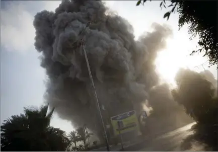  ?? KHALIL HAMRA — THE ASSOCIATED PRESS ?? Smoke raises Saturday after an Israeli airstrike hit a government­al building in Gaza City, Gaza. The Israeli military carried out its largest daytime airstrike campaign since the 2014 war as Hamas militants fired dozens of rockets into Israel.