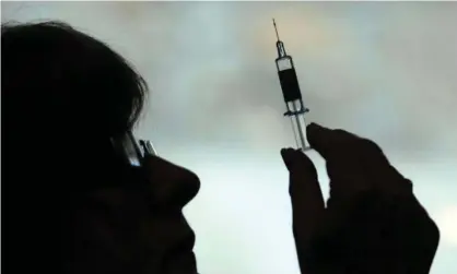  ?? Photograph: David Cheskin/PA ?? A nurse preparing to give a patient a Covid-19 vaccine.