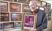  ?? Kelly J. Huff / MDJ ?? The Rev. Henry Holley, the sole survivor of the original crusades team for the Rev. Billy Graham, cherishes the personaliz­ed picture Graham gave him years ago. Holley was part of the team for over 40 years. Behind him are pictures of 22 of the crusades...