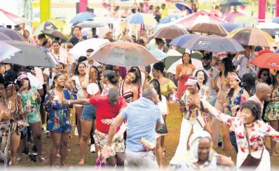  ?? FILE ?? Patrons were prepared to party in the rain at Xodus Debut Breakfast Party inside The Ruins at UWI earlier this year.