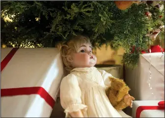  ?? FILE PHOTO/BEN GOFF ?? A doll sits under a Christmas tree in the 1895 Hawkins House during the annual Holiday Open House at the Rogers Historical Museum. Christmas tours continue through December.