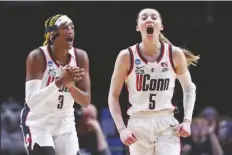  ?? HOWARD LAO/AP ?? UCONN GUARD PAIGE BUECKERS (5) and Uconn forward Aaliyah Edwards (3) react during the first half of the Sweet 16 game against Duke on Saturday in Portland, Ore.