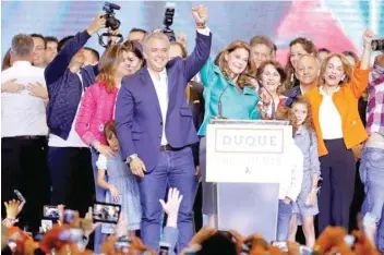  ?? — Reuters ?? Presidenti­al candidate Ivan Duque and his candidate for Vice President Marta Lucia Ramirez celebrate after he won the presidenti­al election in Bogota, on Sunday.