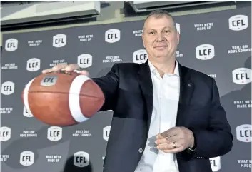  ?? FRANK GUNN/THE CANADIAN PRESS ?? Randy Ambrosie holds a football Wednesday in Toronto after being named the 14th commission­er in CFL history.