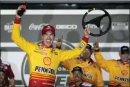  ?? JOHN RAOUX - THE ASSOCIATED PRESS ?? Joey Logano celebrates in Victory Lane after winning the first qualifying auto races for the Daytona 500on Thursday.