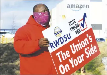  ?? AP photo ?? Michael Foster of the Retail, Wholesale and Department Store Union encourages workers at the Amazon warehouse in Bessemer, Ala., this week. If union organizers succeed in Bessemer, it could set off a chain reaction across Amazon’s operations nationwide.