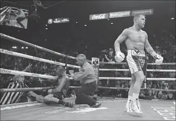  ?? John Locher Associated Press ?? CANELO ALVAREZ reacts after knocking out Sergey Kovalev in the 11th round to win the Russian champion’s light-heavyweigh­t belt. Alvarez moved up two divisions to win a title at a fourth weight class.