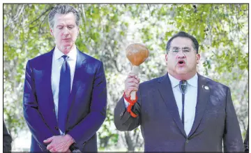  ?? Rich Pedroncell­i The Associated Press file ?? Gov. Gavin Newsom, left, proposed giving $100 million to Native American tribes, that could be used to purchase and preserve their ancestral lands on Friday.