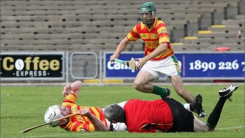  ??  ?? Referee Niall McDonald is sent crashing after an accidental collision with Alley captain Ciarán Kenny, but both were fine afterwards.