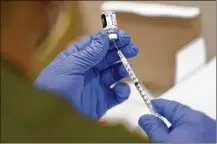  ?? LYNNE SLADKY / AP ?? The government is close to publishing the details of a new vaccinatio­n-or-testing rule covering more than 80 million Americans at companies with 100 or more workers.