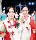  ?? CHHORN NORN ?? Heng Sivlang (right) and sister Sivguek pose with their medals at Phnom Penh airport.