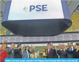  ?? — AFP ?? MANILA: Jose Pardo (center), chairman of the Philippine Stock Exchange (PSE), makes a toast with officials to mark the opening of the PSE’s new building in Taguig City, suburban Manila yesterday.