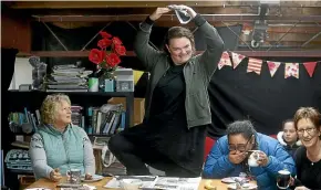  ?? KEVIN STENT/STUFF ?? The staff at Live Wires gift distributi­on company, where quizmaster Britony McLaren is happy to assist the team with a bit of charades. From left: Jenny Naik, Ngawai King and Robyn Ormsby enjoy the show.