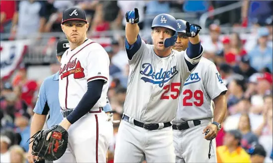  ?? Wally Skalij Los Angeles Times ?? DODGERS’ DAVID FREESE points to the bench after hitting a two-run single for the lead against the Braves in the sixth inning in Game 4 of the NLDS.