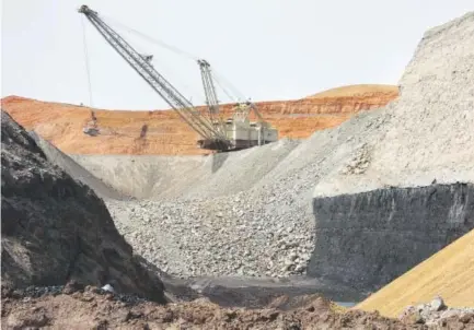  ?? Matthew Brown, The Associated Press ?? A dragline excavator moves rocks above a coal seam at the Spring Creek Mine in Decker, Mont. President Donald Trump’s latest move to back coal mining is unlikely to turn around the industry’s prospects immediatel­y.