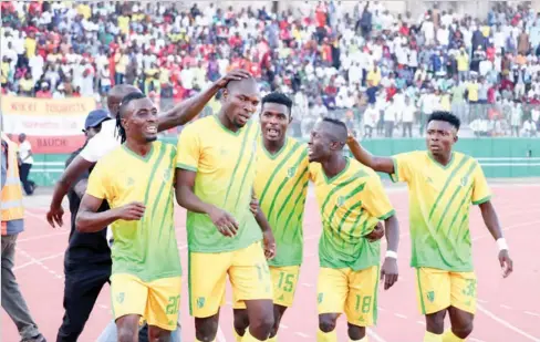  ??  ?? Plateau United players celebrate after scoring a goal during a match in the 2020 NPFL season