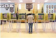  ?? ASSOCIATED PRESS ?? Carolyn Yazzie fills in a ballot in a 2015 election in the Navajo Chapter House in Shiprock, NM. Native Americans in a Utah county sued for the same access.