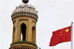  ??  ?? A Chinese national flag flutters near a minaret of the ancient Id Kah Mosque in the Old City in Kashgar in Xinjiang Uighur Autonomous Region, China. Intellectu­al property rights cases can from next month be taken to China’s Supreme Court, the government said, as the country seeks to strengthen protection­s in the face of complaints from the United States about the issue. — Reuters photo