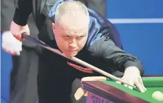  ?? — AFP photo ?? Scotland’s John Higgins plays a shot during the World Championsh­ip Snooker semi-final at The Crucible in Sheffield, England in this May 3 file photo.