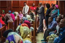  ?? BRIAN OTIENO — THE NEW YORK TIMES ?? People gather inside a courtroom in Nairobi, Kenya for a hearing into a new biometric national identifica­tion system at the end of last year.