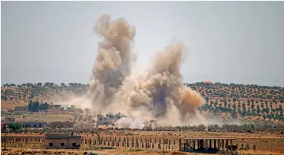  ?? — AFP ?? Smoke rises above eastern rebel-held areas of the city of Daraa during reported air strikes by Syrian forces on Sunday.