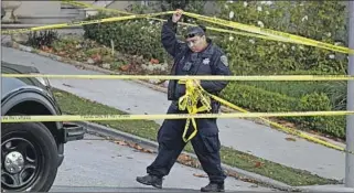  ?? ERIC RISBERG Associated Press ?? CRIME SCENE tape blocked the street below the Pelosi home in San Francisco in October.