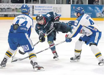  ??  ?? Craig Moore gets his shot away before Flyers Kyle Haines and Brendan Brooks close in.