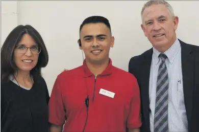  ?? Ryan Painter/For
The Signal ?? Amy and John Noland pose with Steven Torres, center, in this photo taken Thursday. The couple helped Torres after he was struck by a car while on his bike on The Old Road last week. John rescued Torres at the scene, while Amy took to Facebook to seek...