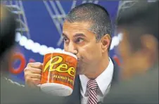  ?? Jacquelyn Martin/Associated Press ?? Federal Communicat­ions Commission Chairman Ajit Pai takes a drink from a mug during an FCC meeting Thursday in which the commission voted to end net neutrality.