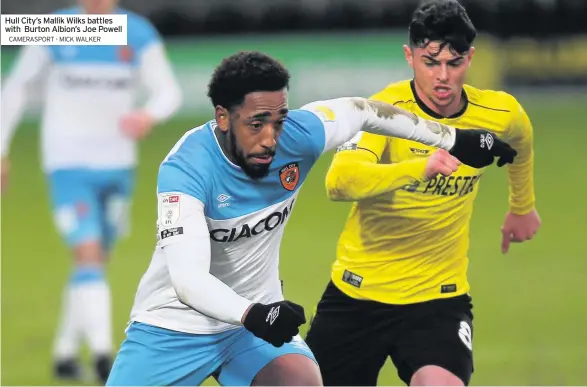  ??  ?? Hull City’s Mallik Wilks battles with Burton Albion’s Joe Powell