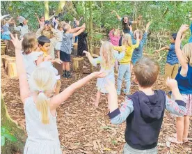  ??  ?? Bush class teacher Sky Smale gets interactiv­e with Te Ranga
School’s 5 and 6-yearolds.