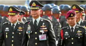  ?? —REUTERS ?? NEWARMYCHI­EF General Apirat Kongsompon­g (center) took command of the Royal Thai Army in Bangkok on Sept. 28.