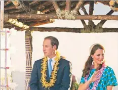  ?? EPA ?? Britain’s Prince William, Duke of Cambridge and his wife Catherine, Duchess of Cambridge stand on a truck decorated as a canoe in Honiara, Solomon Islands as part of the royal couple’s tour to celebrate Queen Elizabeth II’s Diamond Jubilee. See related...