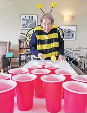  ??  ?? Taking aim Muriel Hosie from Ancaster House takes on the ‘beer pong’ challenge