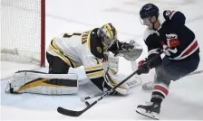  ?? Ap ?? PIPE JOB: Bruins goalie Jeremy Swayman tries to stop Capitals right wing Garnet Hathaway on Thursday.