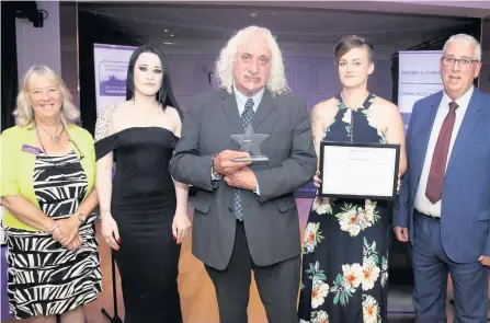  ??  ?? ● Presenting the Community Champion Award is North Wales Police and Crime Commission­er Arfon Jones (right) with, from left, Deputy Commission­er Ann Griffith, and Bobbie Roberts, award winner Kenny Khan and Helen Evans, of Cegin Cofi