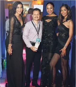  ??  ?? John Woolcock (second from left) Groups and Convention­s Manager Jamaica Tourist Board seems pleased to be in the company of ‘Bond girls’ Jovanni Davis, Candice McLeod, Kareen Hall.