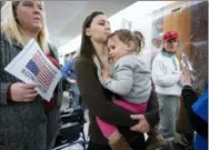  ?? J. SCOTT APPLEWHITE — THE ASSOCIATED PRESS ?? Sarah Myriam of New Jersey holds her daughter Aliyah, 2, as they join activists opposed to vaccinatio­ns outside a Senate Health, Education, Labor and Pensions Committee hearing on the safety of vaccines, on Capitol Hill in Washington, Tuesday.