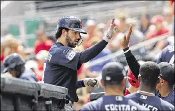  ?? JOHN BAZEMORE / ASSOCIATED PRESS ?? Dansby Swanson is greeted at the dugout by his teammates after hitting a home run in the first inning of Thursday’s game against the Cardinals. Despite taking an early 3-0 lead, the Braves were defeated 9-4 in Jupiter, Fla.